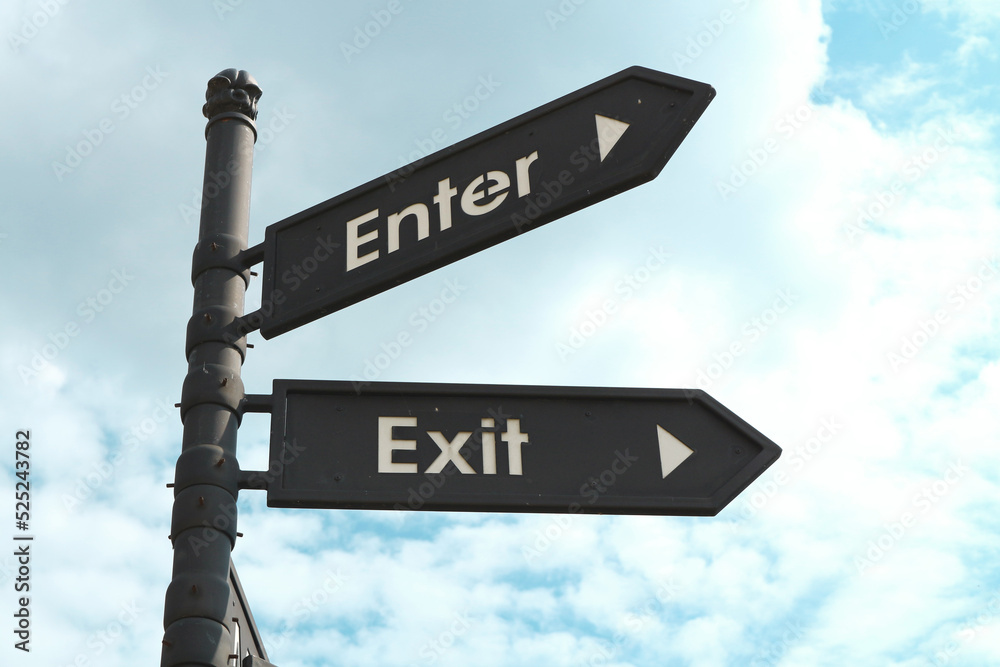 Fototapeta premium Pointer to the entrance and exit against the sky.