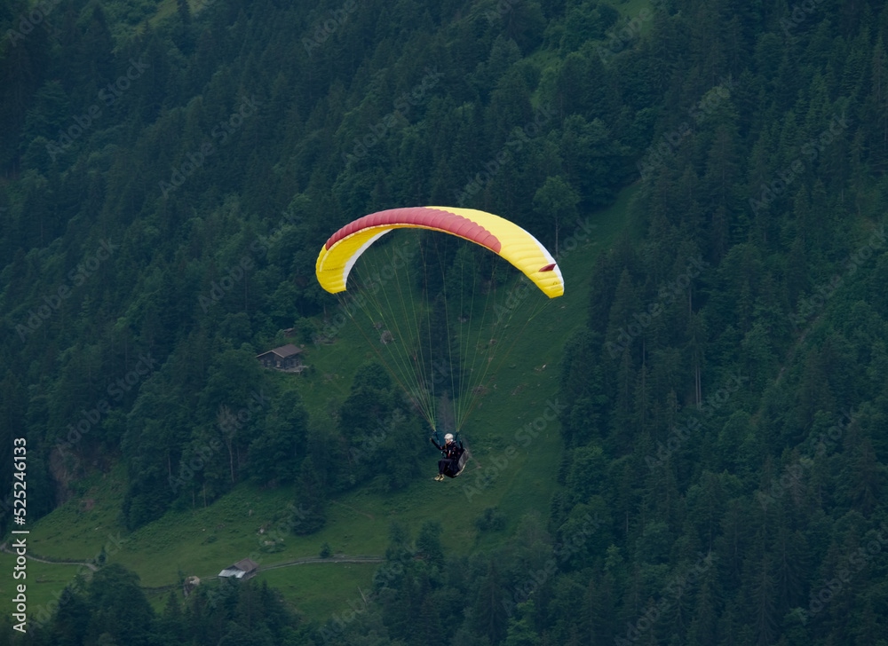 A picture with motion blur and noise effect of paragliding at Lauterbrunnen Valley A picture with motion blur and noise effect of paragliding at Lauterbrunnen Valley