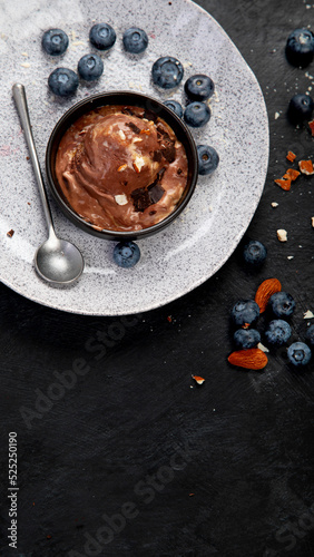 Chocolate ice cream with berries on dark background