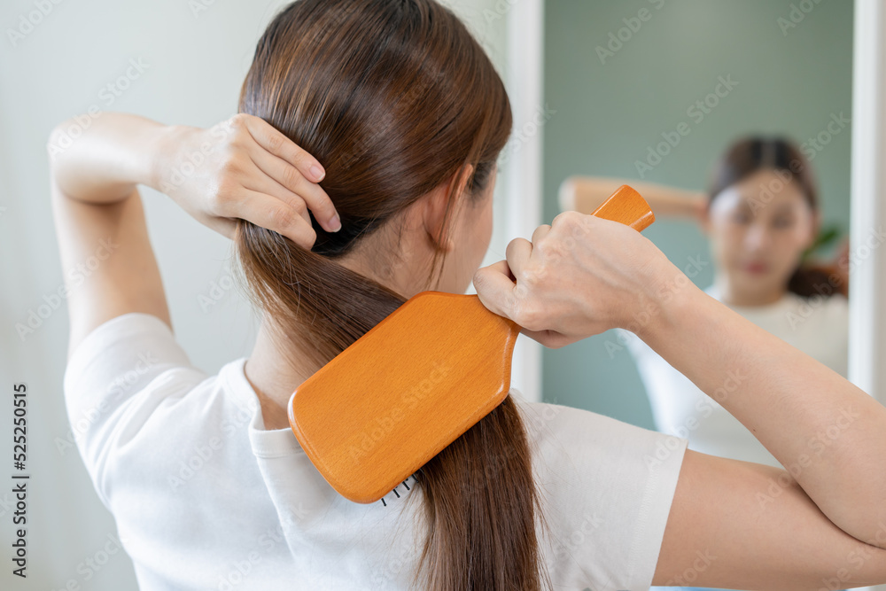 Φωτογραφία Health hair care, beauty makeup asian woman hand in holding hairbrush and brushing, combing her long straight hair reflection in mirror in morning routine after salon treatment at home, hairstyle