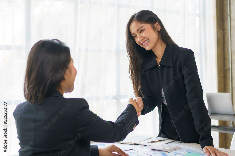 Business people shaking hand to agree to enter into a joint venture agreement to do business together in a new business. Business people shaking hand to agree to enter into a joint venture agreement to do business together in a new business.