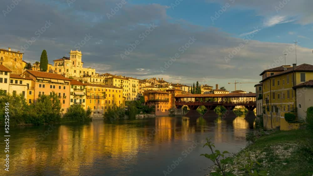 the old wooden bridge spans the river brenta at the romantic village Basano del Grappa. Timelapse at sunset the old wooden bridge spans the river brenta at the romantic village Basano del Grappa. Timelapse at sunset
