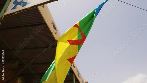 berber flag hoisted in a store in southern Morocco. Berber, self-name Amazigh, plural Imazighen, any of the descendants of the pre-Arab inhabitants of North Africa. photo