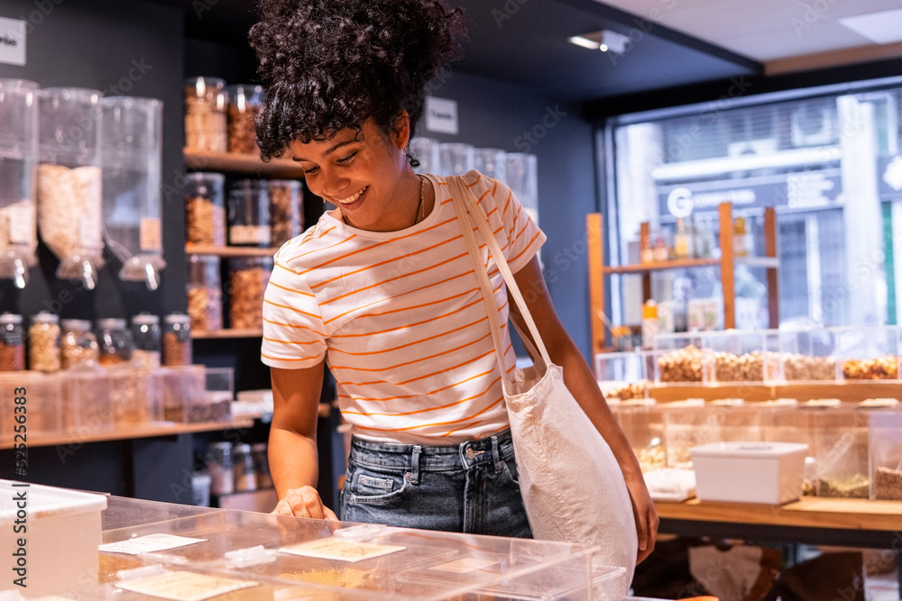 Happy black customer visiting eco friendly grocery shop Happy black customer visiting eco friendly grocery shop
