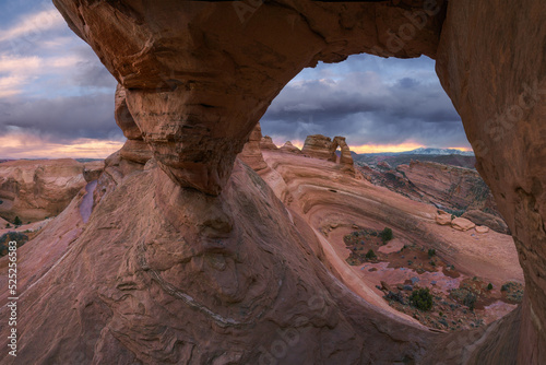 Natural stone arch against cloudy sky photo