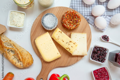 Various types of cheese on cutting board photo