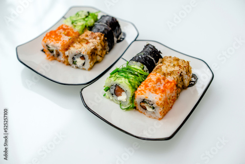 Several sushi on a white plate standing on a white background
