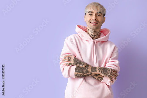 Young tattooed man in pink ...
