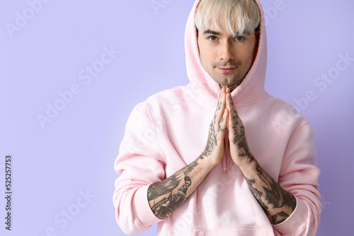 Young tattooed man in pink ...