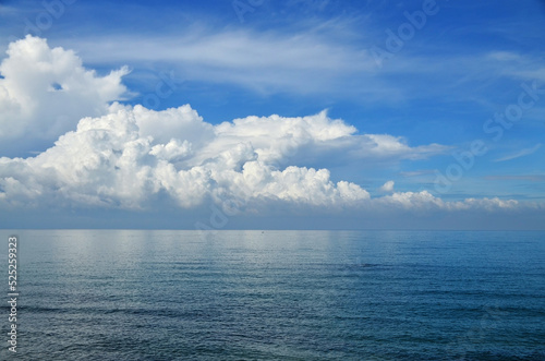 blue sea and sky with white clouds.