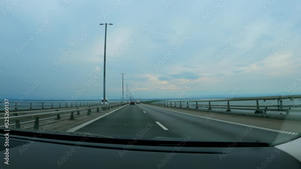 Driving on the Øresund Bridge spanning between Denmark and Sweden. Large suspension bridge. Driving on the Øresund Bridge spanning between Denmark and Sweden. Large suspension bridge.