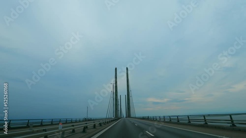 Driving on the Øresund Bridge spanning between Denmark and Sweden. Large suspension bridge.
