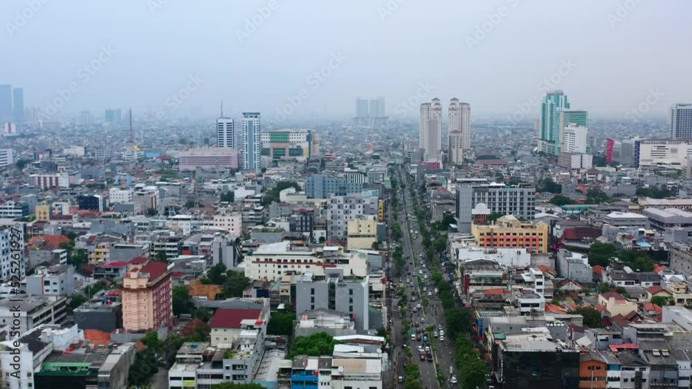 aerial pan over Jakarta skyline and highway transportation on day with poor air pollution aerial pan over Jakarta skyline and highway transportation on day with poor air pollution