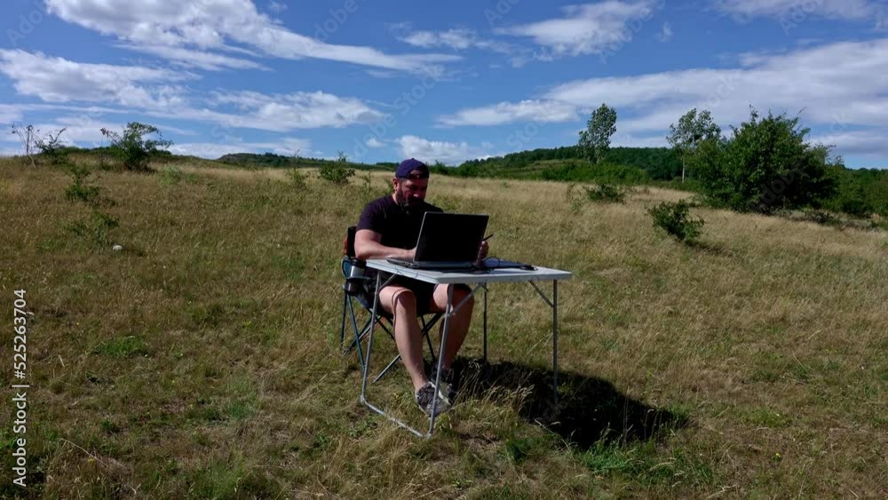 Graphic designer with laptop sitting and working with laptop and graphic tablet outdoor Graphic designer with laptop sitting and working with laptop and graphic tablet outdoor