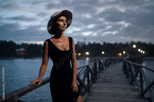 Vacation on tropical island. Young woman in hat enjoying sea view from wooden bridge terrace, Siargao Philippines. © luengo_ua