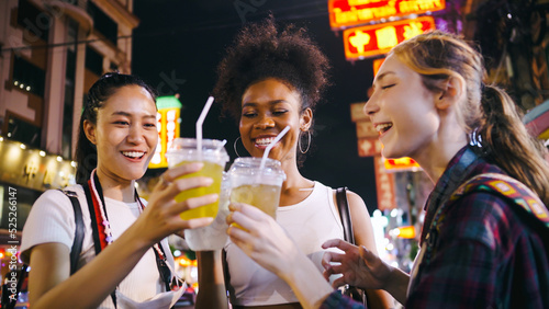 Groups of multi-ethnic female friends are enjoying a night out on Yaowarat Road or Chinatown in Bangkok, Thailand.