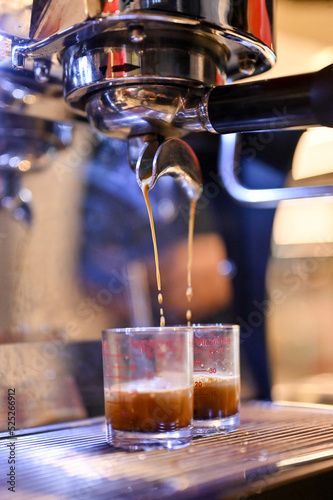 Close up Espresso machine making coffee, golden espresso flowing. Coffee espresso.(Selective Focus)