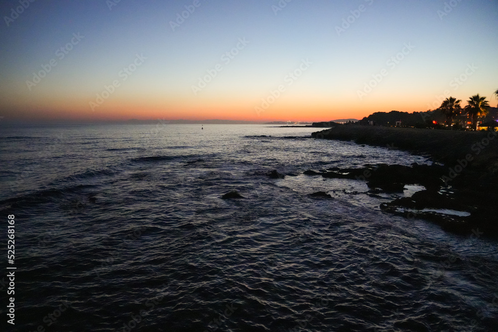 Beach on the Mediterranean Sea in the Turkish Reviera. Coast at sunset near Alanya in Turkey.
