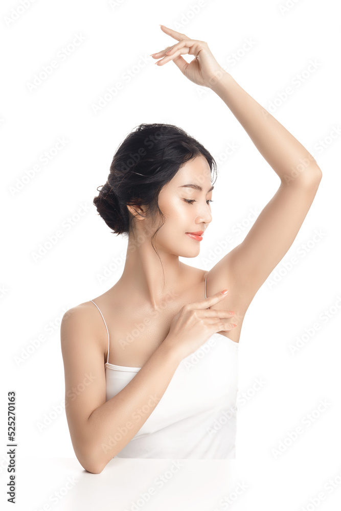 Asian woman with a beautiful face and Perfect clean fresh skin. Cute female  model rising arm show her armpit on white isolated background. Facial  treatment, Cosmetology, beauty Concept. Stock Photo