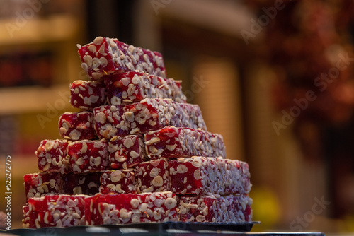 Turkish Delight with hazelnuts standing in the showcase. Red delight.
