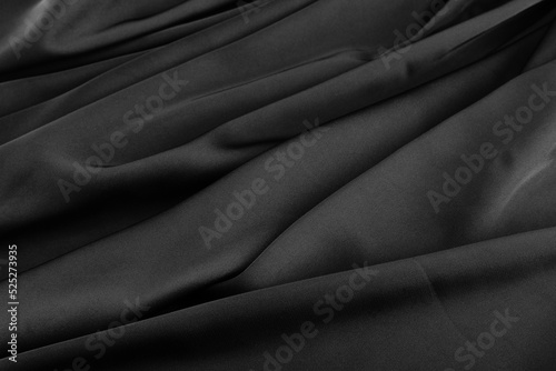 Folds of black silk fabric.