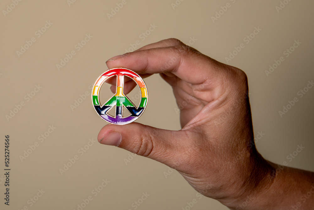 Peace sign in hand, rainbow colors. Love and equality concept Peace sign in hand, rainbow colors. Love and equality concept