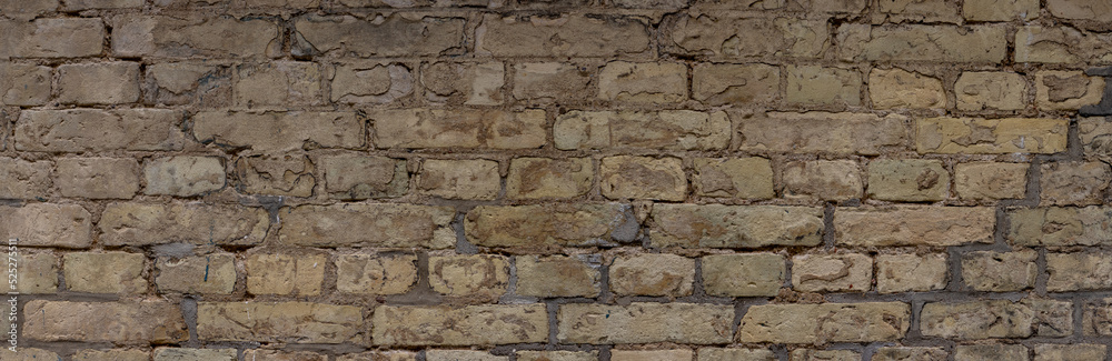 Wide weathered beige brown brick wall background