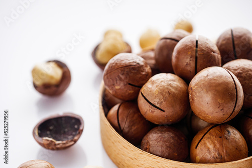 fresh macadamia nuts on a white acrylic background