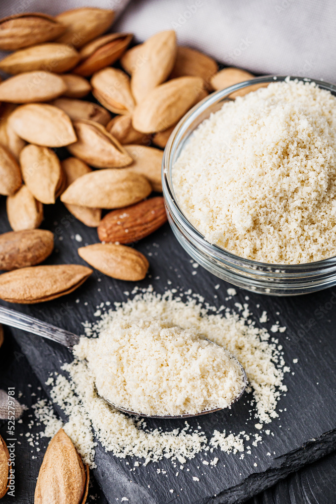 almond flour on a black wooden rustic background almond flour on a black wooden rustic background
