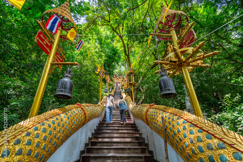 The stairs with a gold serpent statue at Wat Cha Am Khiri, Phetchaburi, Thailand photo