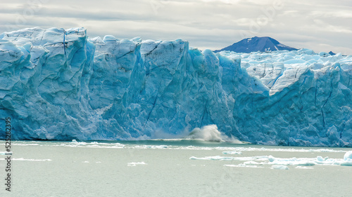 A giant chunk of ice breaking off the magnificent Perito Moreno Glacier in Patagonia, Argentina.