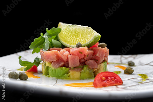 Salmon tartar with avocado, arugula and lime