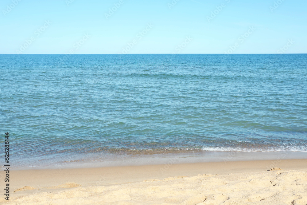 Beautiful view of sea shore under blue sky on sunny day