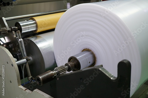 Fotografie The winding unit of blown film machine consists of stainless steel roll and paper core