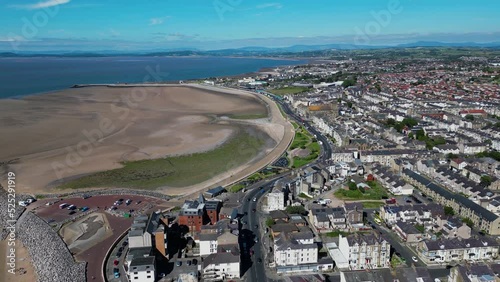 4K: Aerial Drone Video of Morecambe Bay in Lancashire, UK. Approach shot with Beach & Jetty. Stock Video Clip Footage. Wide  photo