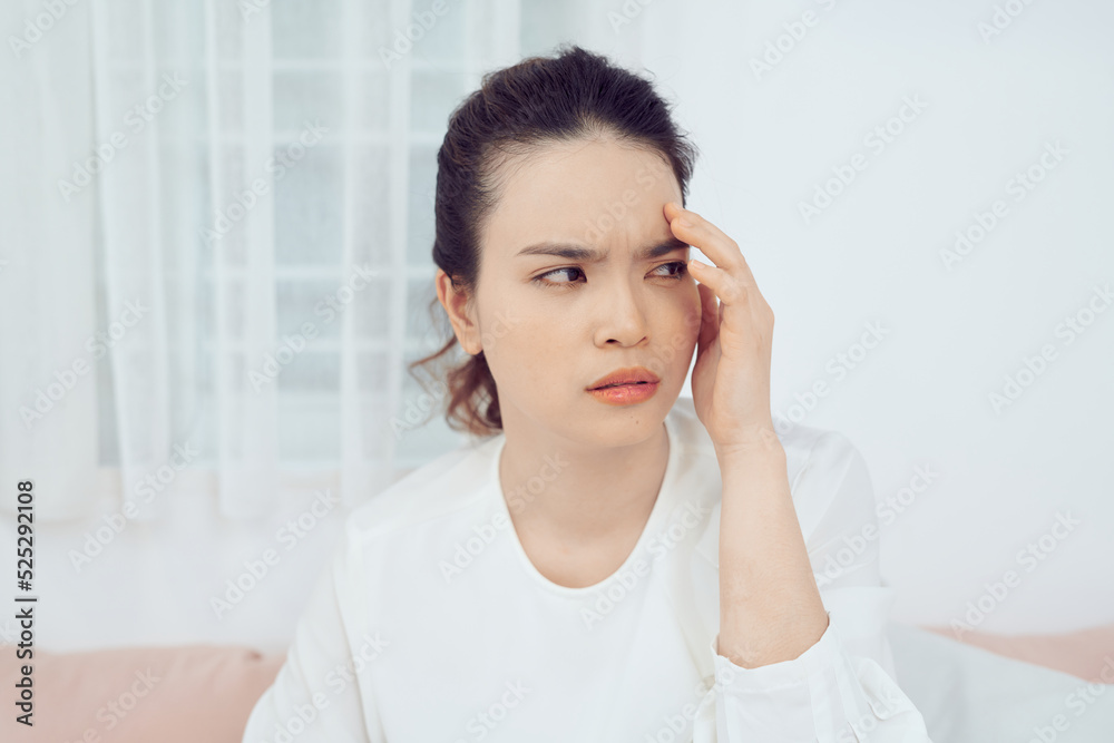 Sick woman covered with a blanket lying in bed with high fever and a flu, resting. Sick woman covered with a blanket lying in bed with high fever and a flu, resting.