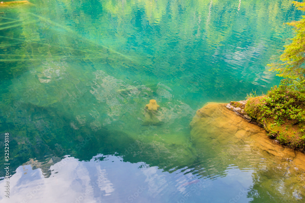 Underwater statue of young girl in Blausee lake (Blue Lake) in Bernese Oberland, Kandergrund, Switzerland