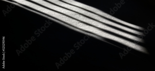 Light in the darkness in prison. Abstract reflection of light from a window with bars on the floor
