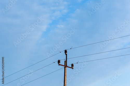 Old electric pole with blue sky