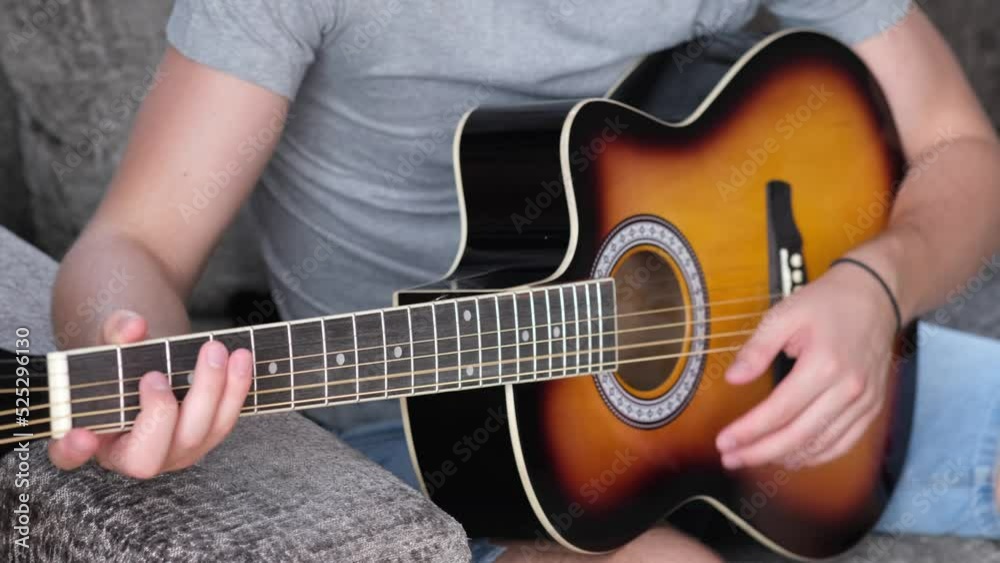 Man learning to play the guitar at home. Practicing in playing guitar. Man learning to play the guitar at home. Practicing in playing guitar.