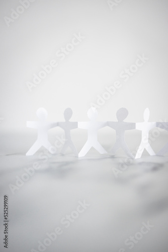 Canvas Print manpower and teamwork, paper people chain with text on white marble background