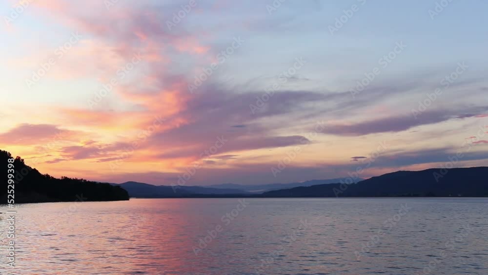 Beautiful sunset landscape from the lake with mountains in background Beautiful sunset landscape from the lake with mountains in background