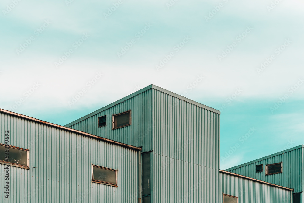 Old industrial building against overcast sky Old industrial building against overcast sky