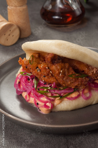 bao bun with breaded chicken, pickled onion and sauce