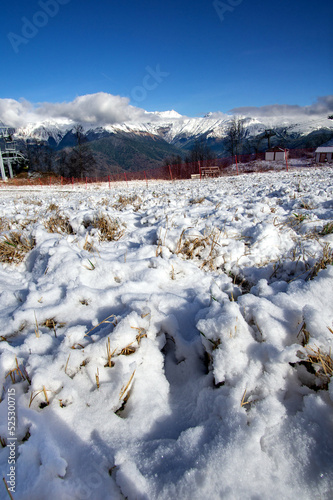 Peaks of a mountain range with cumulus clouds in Krasnaya Polyana photo