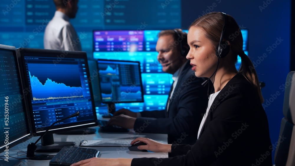 Team of brokers is working in office using workstation and analysis technology. Workplace of professional traders. Global financial markets, business strategy, currency exchange and banking. Team of brokers is working in office using workstation and analysis technology. Workplace of professional traders. Global financial markets, business strategy, currency exchange and banking.