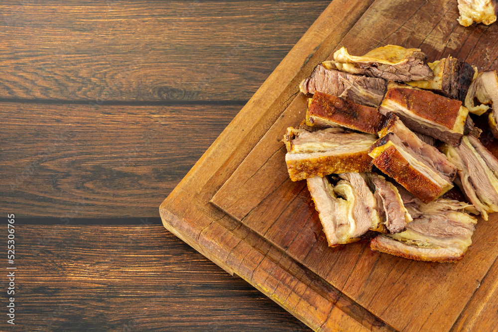 bovine ribs, roasted and sliced on a cutting board with copy space