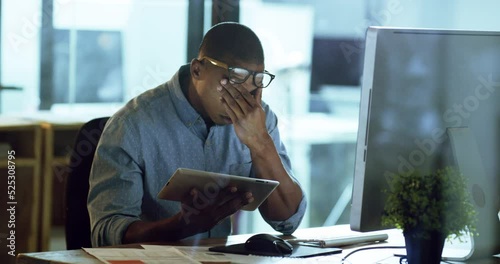 Stress, anxiety and burnout with a business man working on a tablet in his office for overtime at night. Depression, tired and headache with a male worker struggling with mental health and compliance