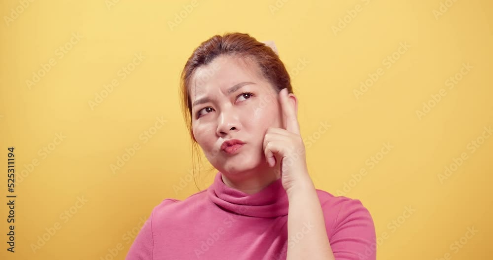 Clever woman considering a serious plan, solving the problem in mind and nodding approvingly, thinking over a smart idea, pondering and musing answer. indoor studio shot isolated on yellow background Clever woman considering a serious plan, solving the problem in mind and nodding approvingly, thinking over a smart idea, pondering and musing answer. indoor studio shot isolated on yellow background