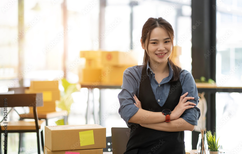 Young attractive asian woman owner startup business look at camera work happy with box at home prepare parcel delivery in sme supply chain Young attractive asian woman owner startup business look at camera work happy with box at home prepare parcel delivery in sme supply chain